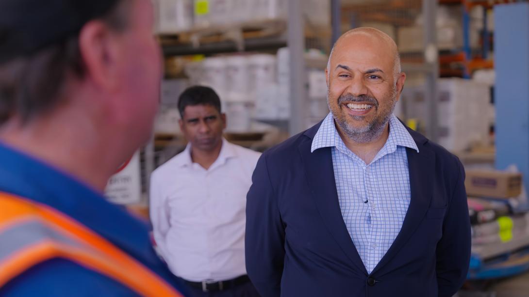 Harpinder Sandhu talking to stakeholders in a wharehouse