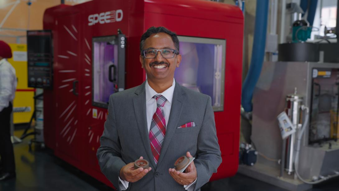 Professor Suresh Palanisamy holding 3D printed parts
