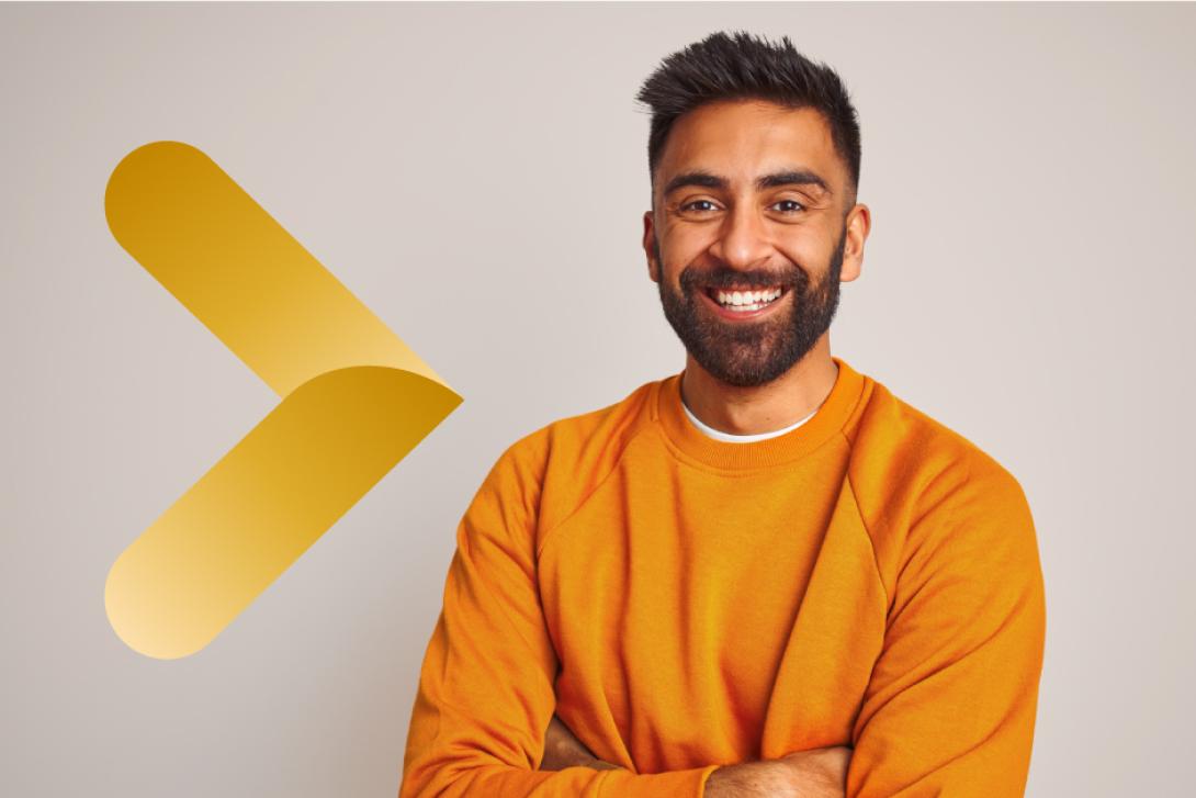 Man smiling in orange jumper with gold graphic arrow