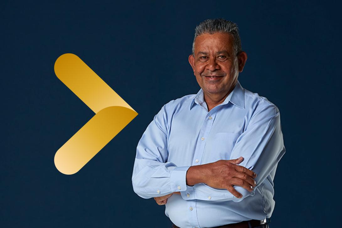 Man on navy background with brand arrow