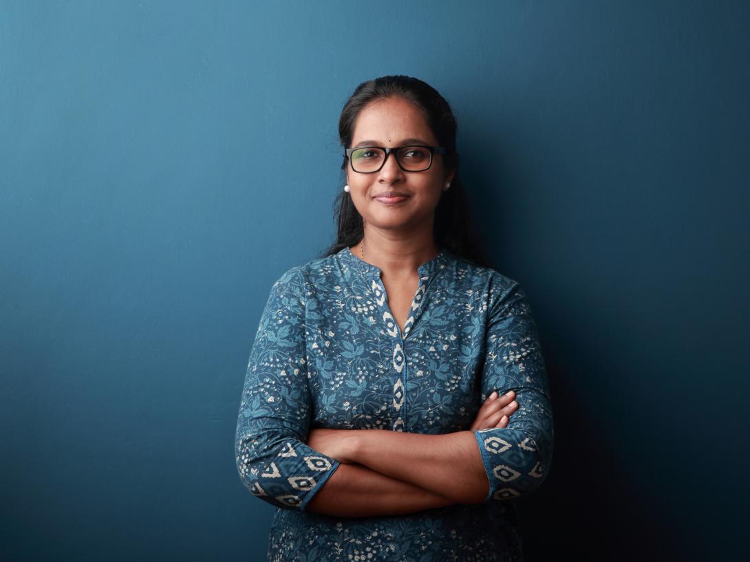 Smiling woman wearing glasses arms crossed