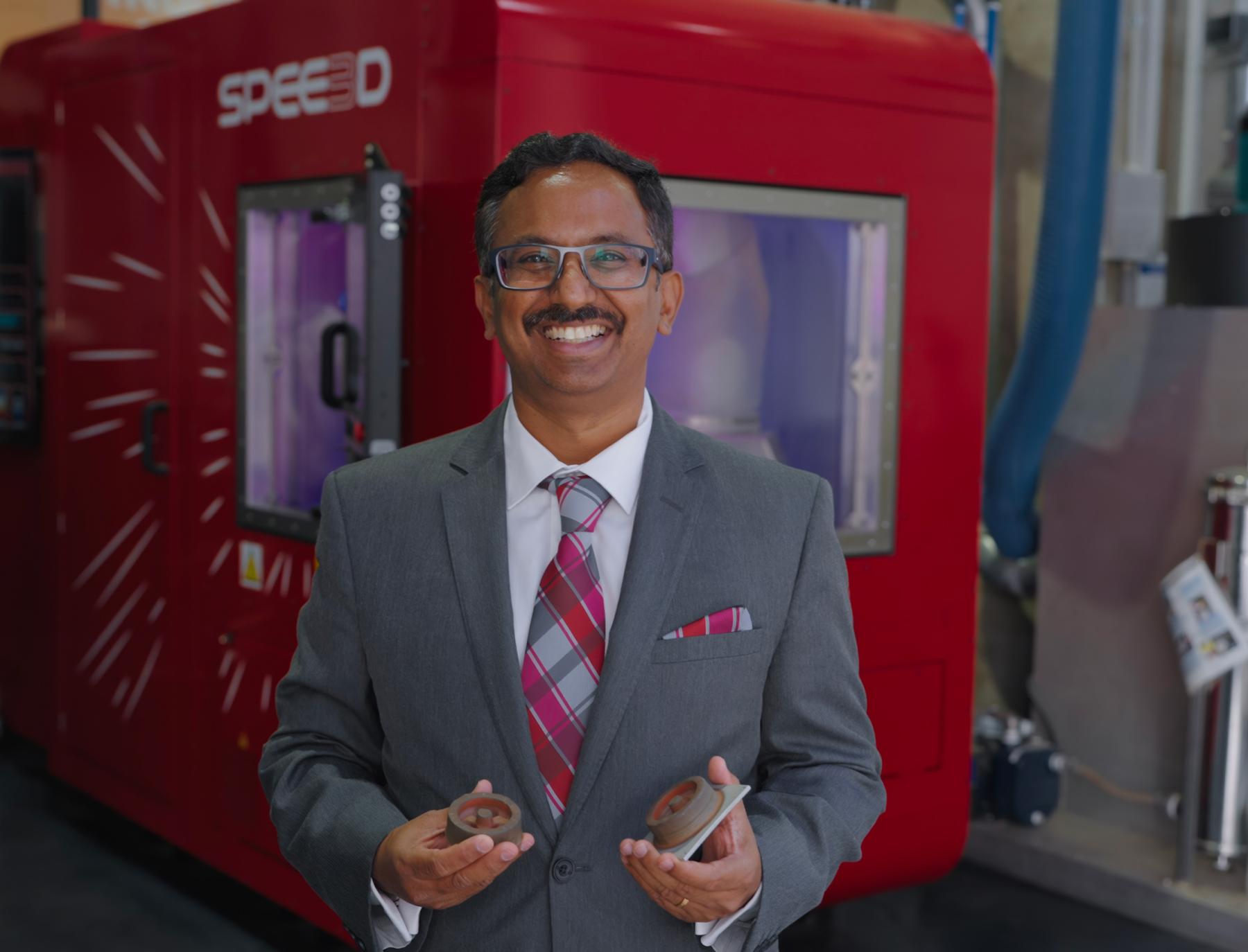 Professor Suresh Palanisamy holding 3D printed parts