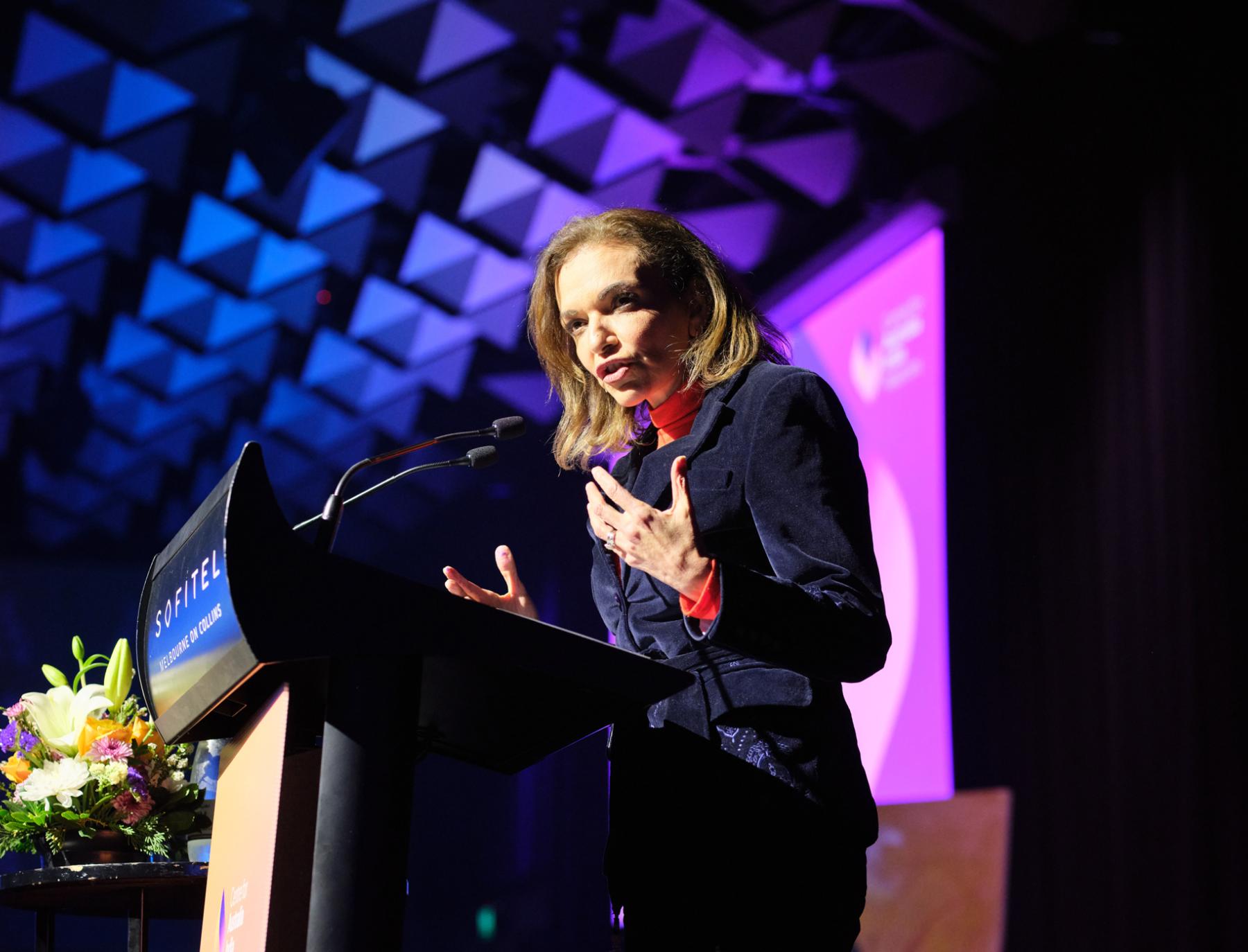 Speaker at podium giving talk at Maitri Showcase 2025