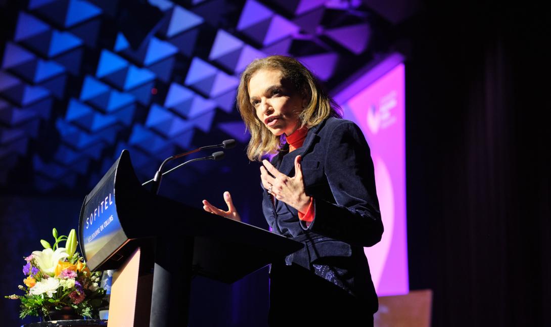 Speaker at podium giving talk at Maitri Showcase 2025